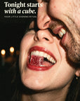 Tonight starts with a cube: a woman laughing with a Desire Cube between her teeth, her partner cheek to cheek