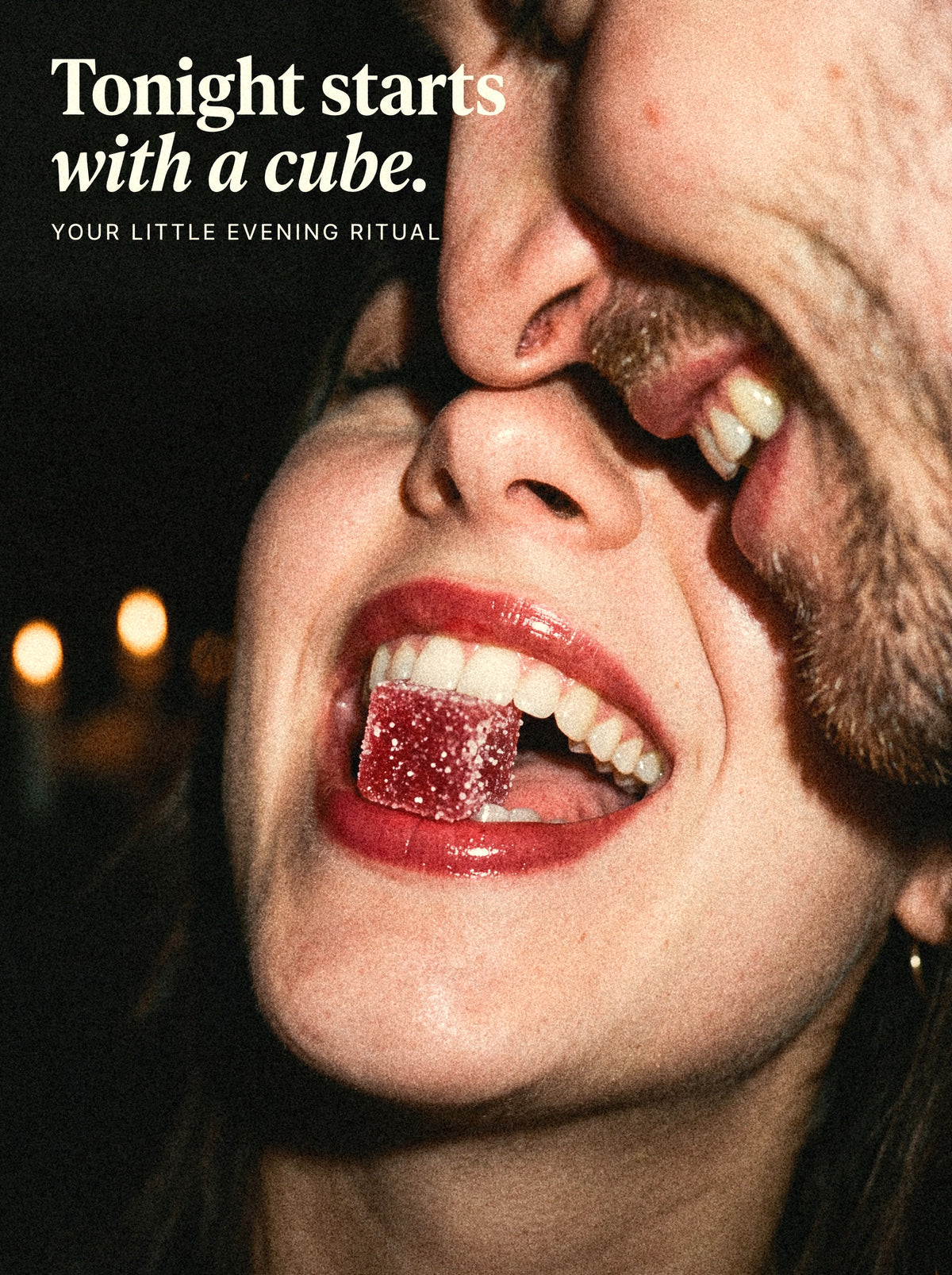 Tonight starts with a cube: a woman laughing with a Desire Cube between her teeth, her partner cheek to cheek