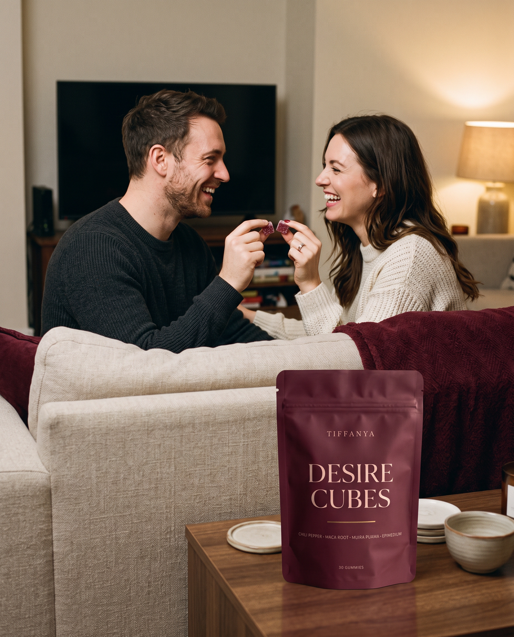 A couple on the sofa clinking two Desire Cubes together