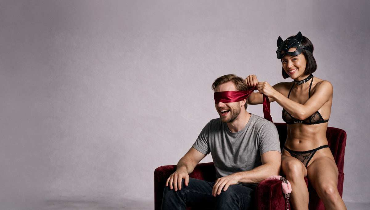 Couple playing with Tiffanya accessories: satin blindfold, cat mask, name choker and fluffy cuffs